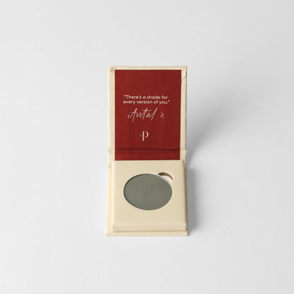 Pressed eyeshadow pan, muted green round compact in a cardboard box