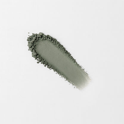 Matte pressed eyeshadow swatch, muted olive green on skin