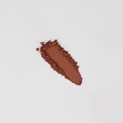 Matte pressed eyeshadow swatch, warm reddish-brown