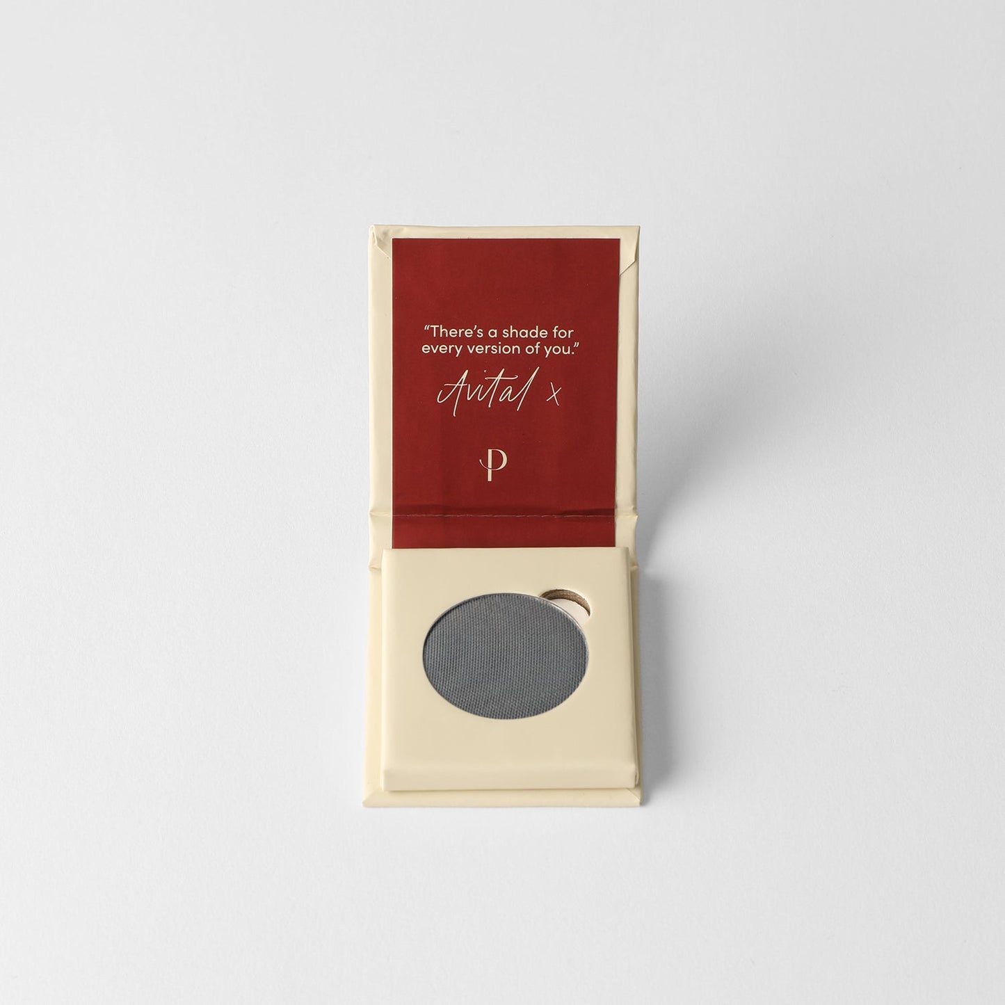 Pressed eyeshadow pan, cool gray round compact in a cardboard box