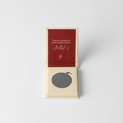 Pressed eyeshadow pan, cool gray round compact in a cardboard box