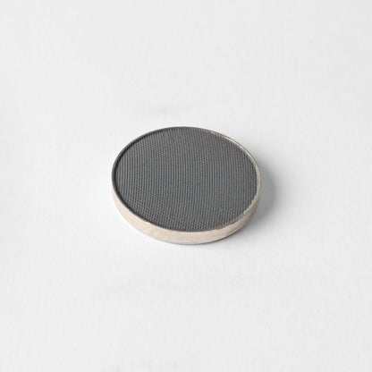 Matte pressed eyeshadow compact, dark gray pan with textured surface
