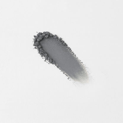 Matte pressed eyeshadow swatch, dusty gray streak on skin
