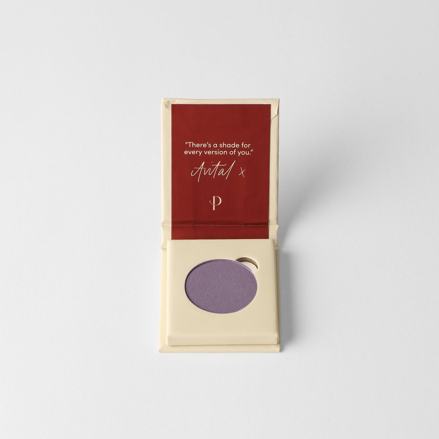 Pressed eyeshadow pan, lilac purple round compact in a cardboard box
