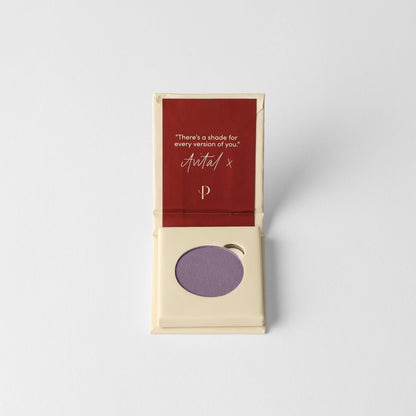 Pressed eyeshadow pan, lilac purple round compact in a cardboard box