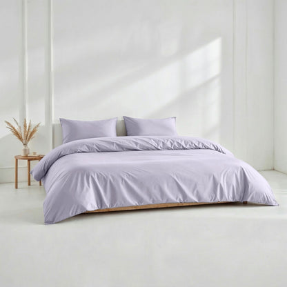 Lilac sateen pillowcase set with two matching pillows on a bed