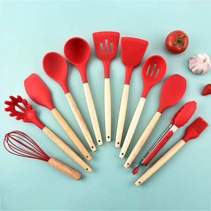 Red silicone cooking utensils with wooden handles, including spatula, spoon, and fork tools