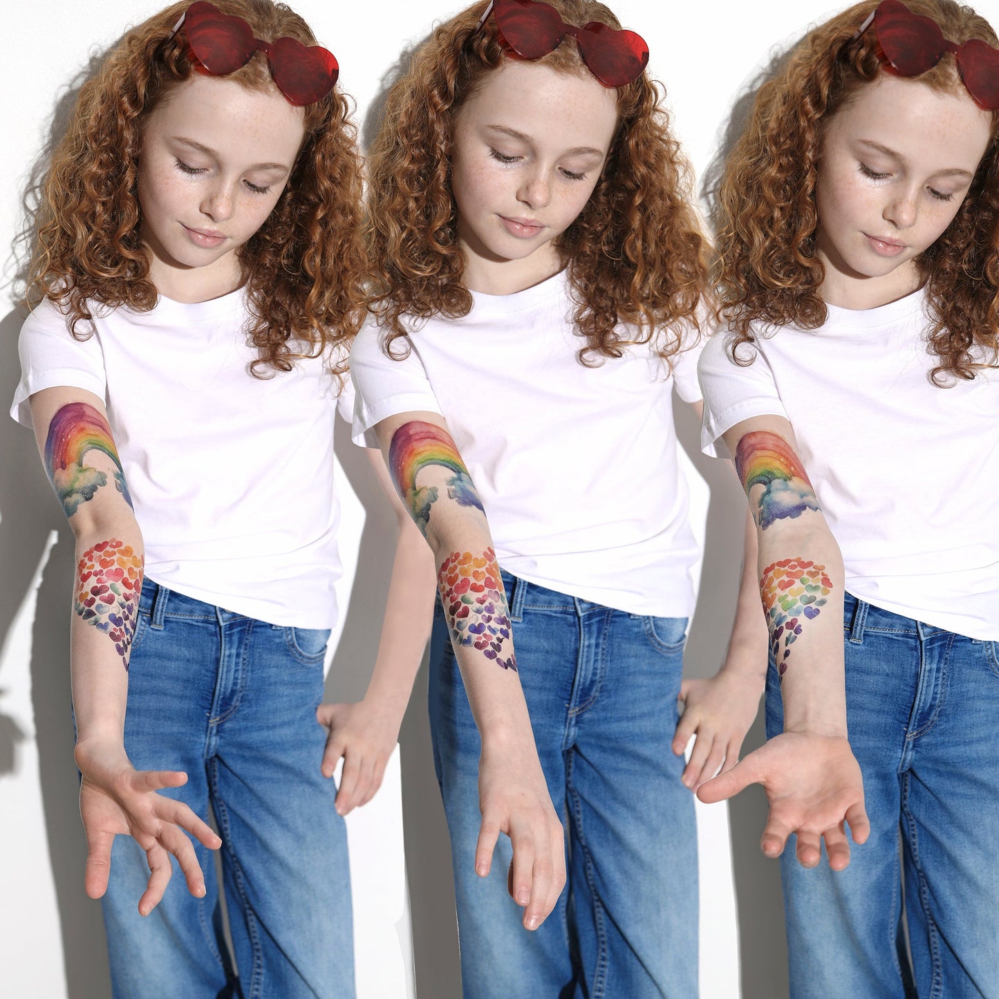 Temporary tattoo sleeve designs on kid’s arms: rainbow, hearts, and clouds