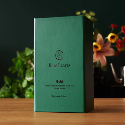 Gold black tea carton, green box with Rare Leaves branding