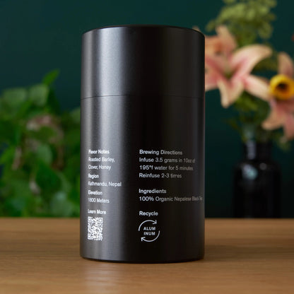 Gold black tea tin, back label with brewing directions on black canister