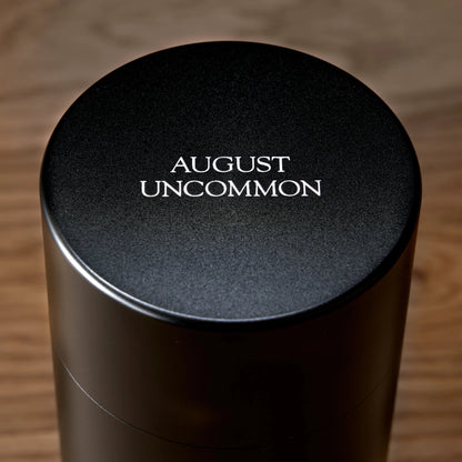 Gold black tea tin lid, black top with AUGUST UNCOMMON text