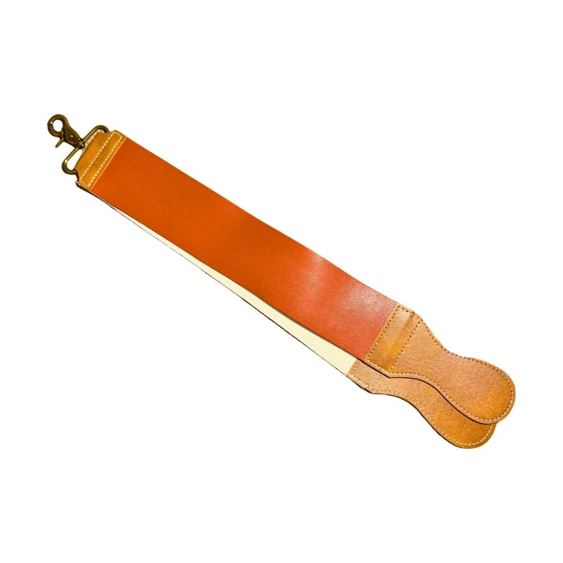 Orange leather razor strop with tan underside and stitched curved ends