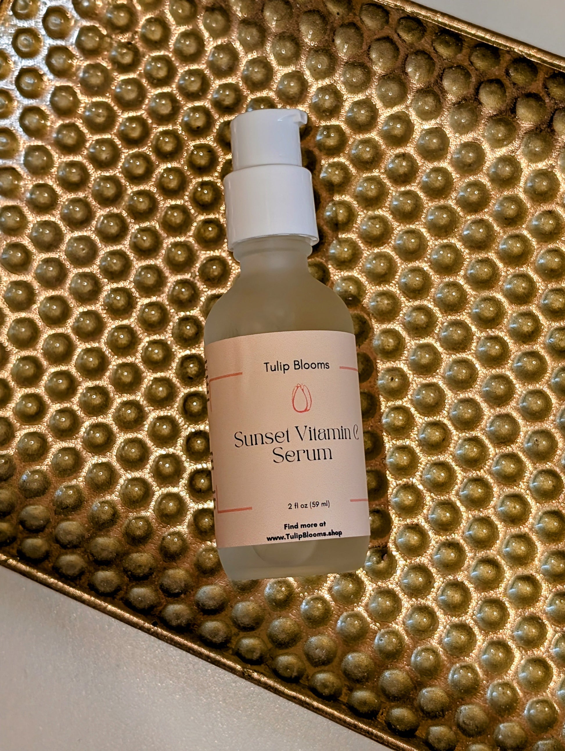 Vitamin C serum bottle with white pump cap