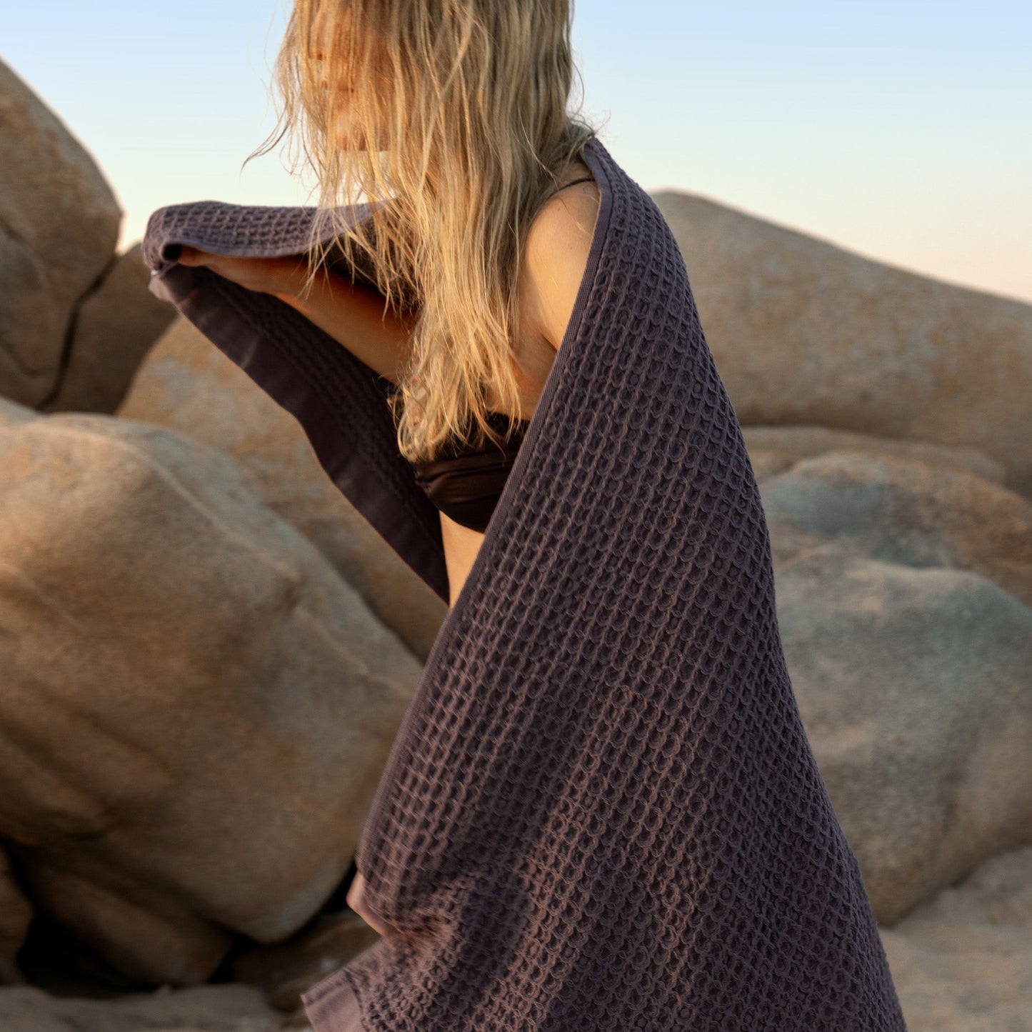 Charcoal waffle weave towel draped over seating, textured grid surface