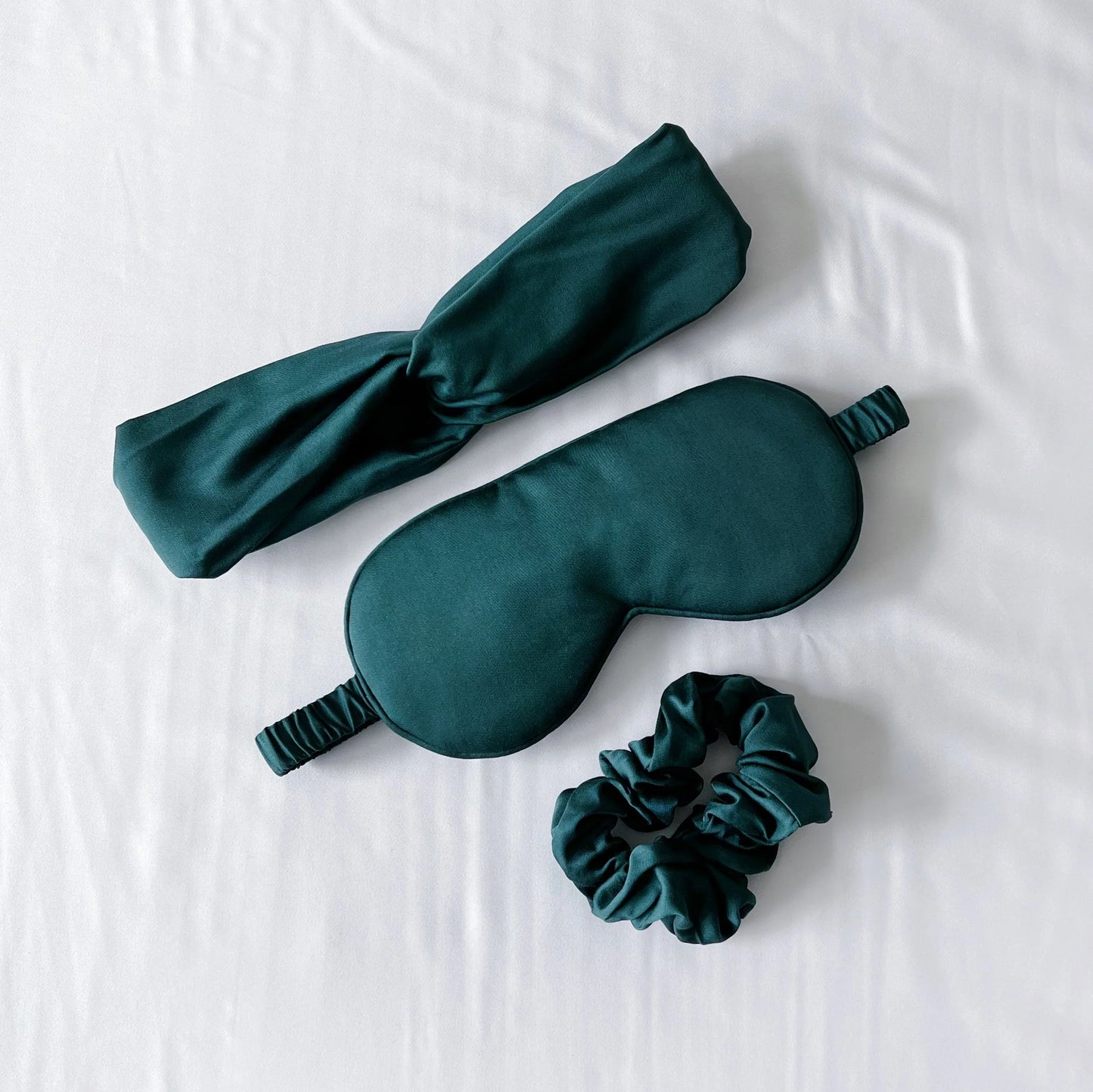 Bamboo sleep care set with dark teal eye mask, headband, matching scrunchie