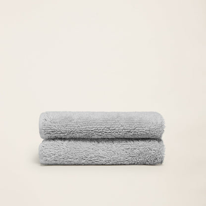 Light gray cotton bath towels, plush terry, folded set of two