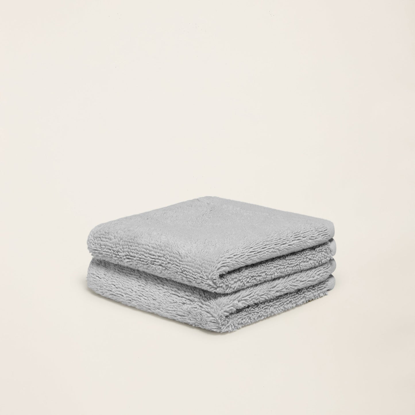 Light gray cotton towel set, folded square with plush texture