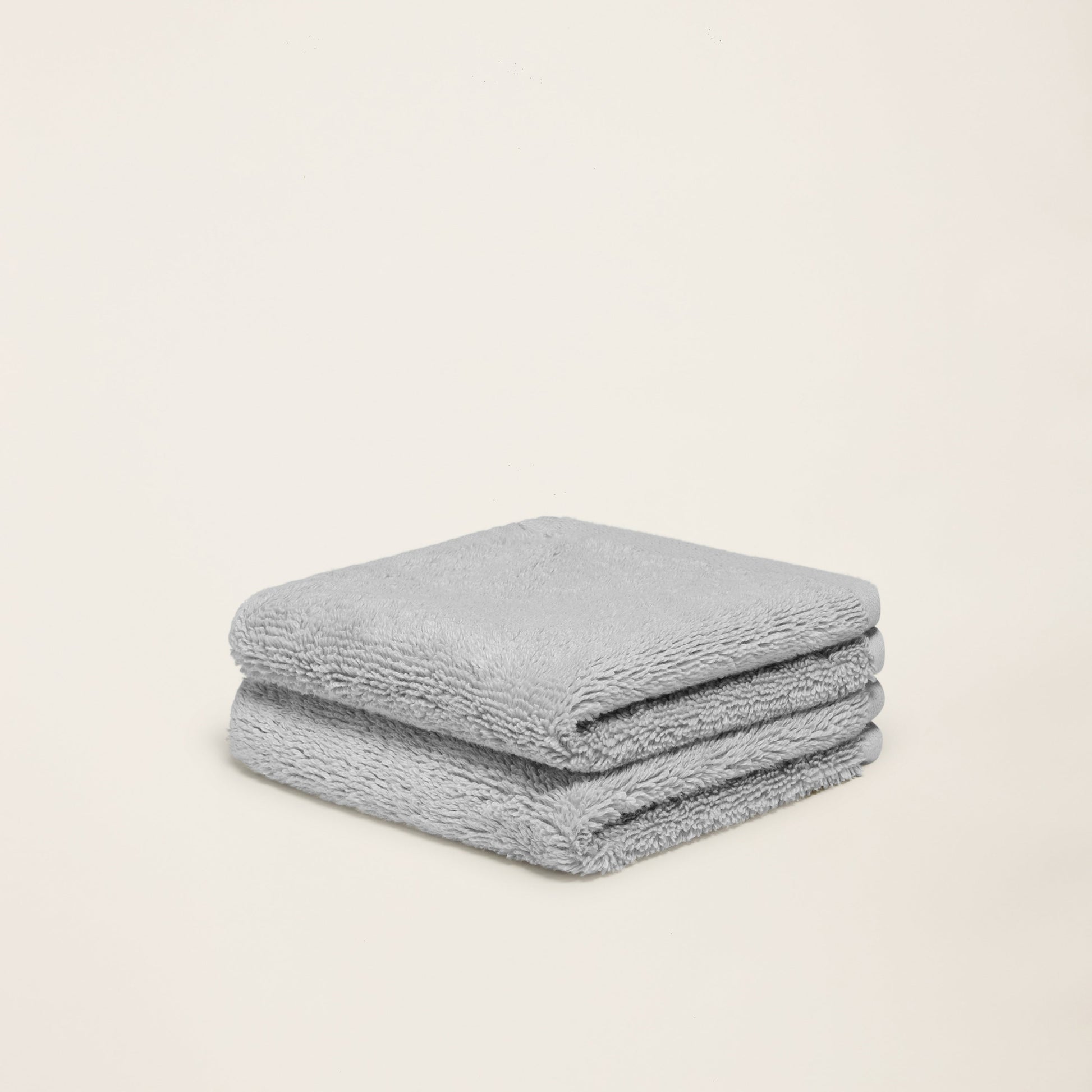 Light gray cotton towel set, folded square with plush texture