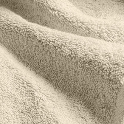 Cream cotton towel fabric close-up with dense plush looped pile