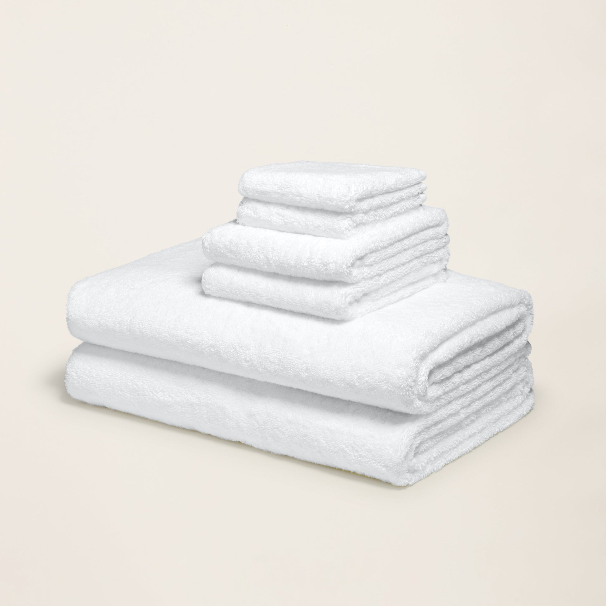 White cotton towels folded in a stack, soft plush texture
