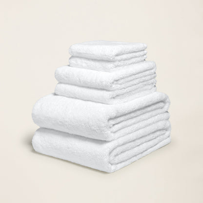 White cotton towel set with plush looped texture, folded and stacked