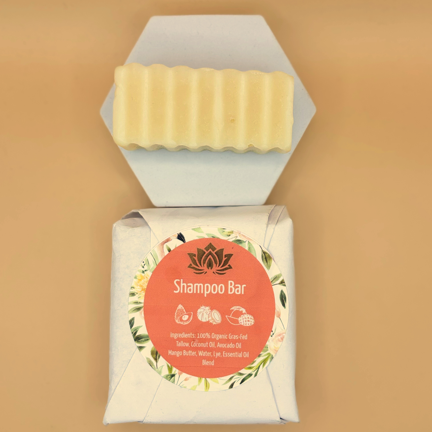 Shampoo bar package with round label and pale yellow tallow bar on top