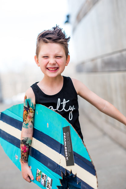 Temporary kids tattoo sleeve on a child’s arm, featuring colorful shark-themed graphics