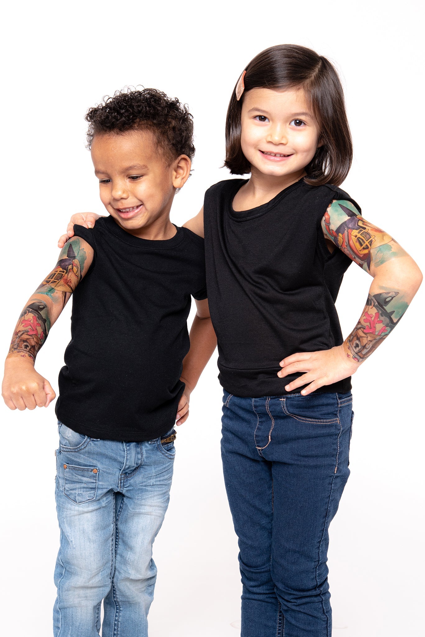 Temporary kids tattoo sleeve on two children’s arms, colorful shark-attack artwork