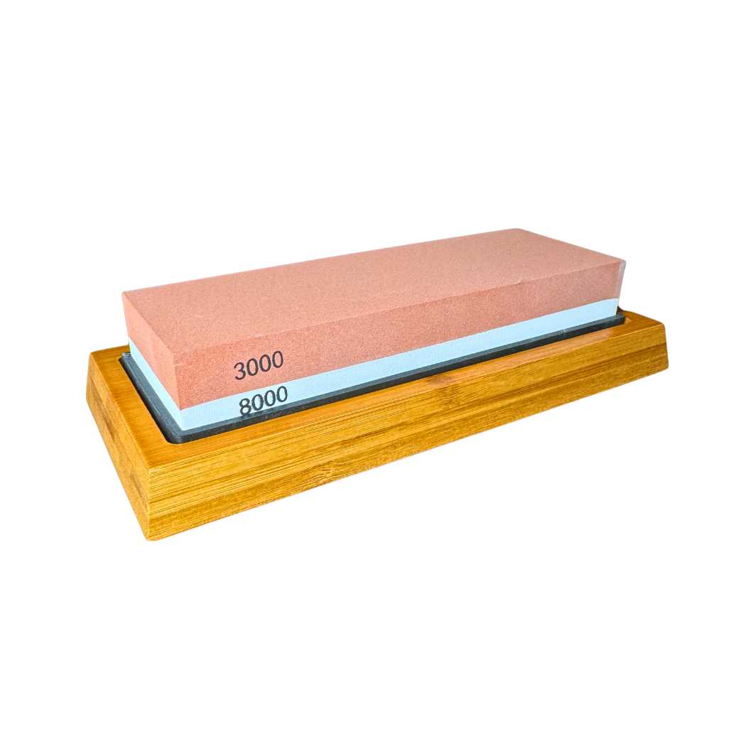 Sharpening stone with reddish 3000/8000 grit face on wooden base