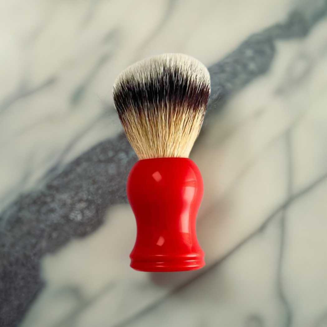 Shaving brush with red handle and mixed light and dark bristles