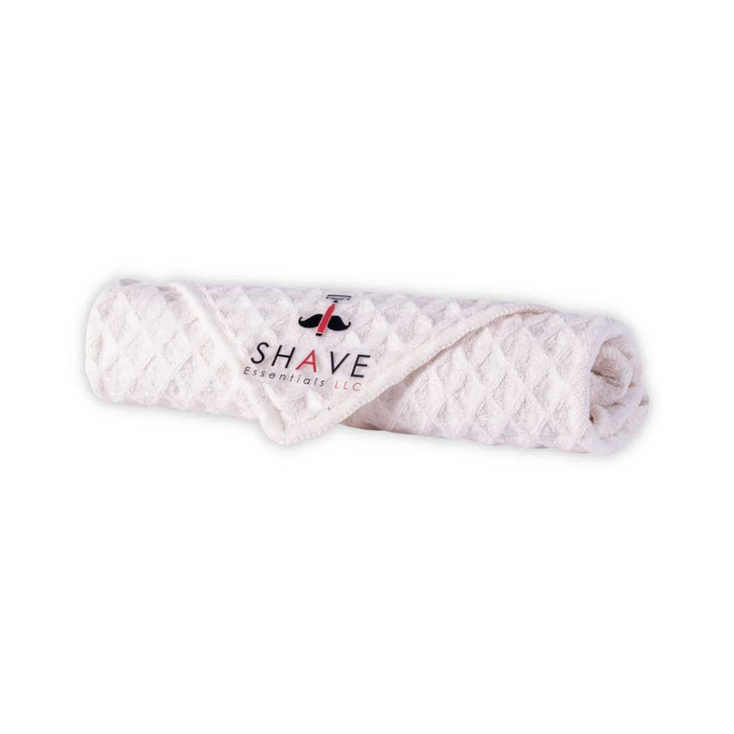 Men's grooming kit folded towel with SHAVE Essentials label
