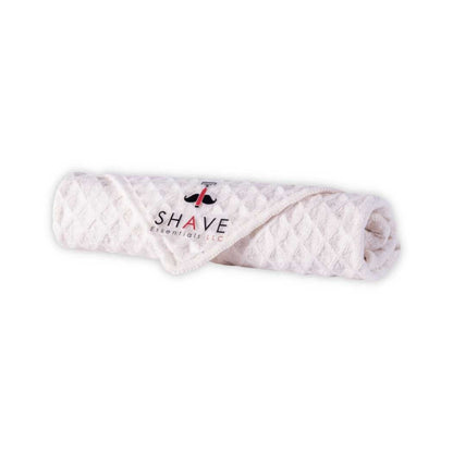 Men's grooming kit folded towel with SHAVE Essentials label