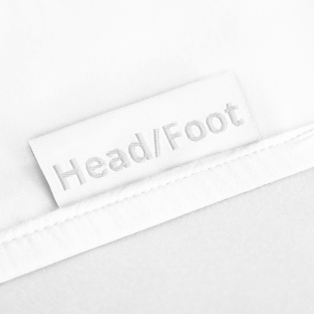 White fitted massage table sheet label detail, HeadliFOOT tag