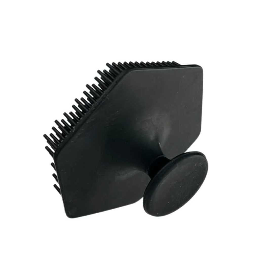 Black silicone face scrubber head with dense bristles and suction base