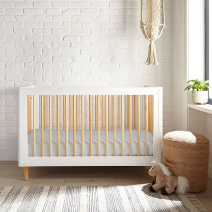 Crib fitted sheet in white, fitted smooth fabric covering the mattress