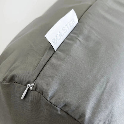 Light gray bolster pillowcase close-up, BOLSTER label and zipper detail.