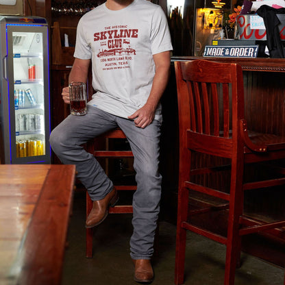 White Skyline Club T-shirt with front graphic worn by a person