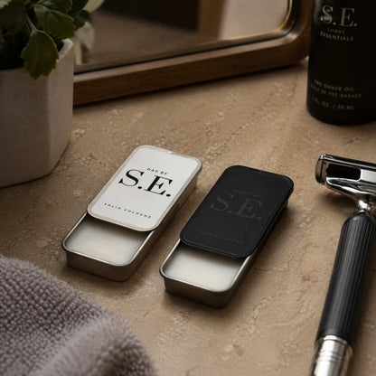 Solid cologne tins on countertop, Day by S.E. and NIGHT by S.E.