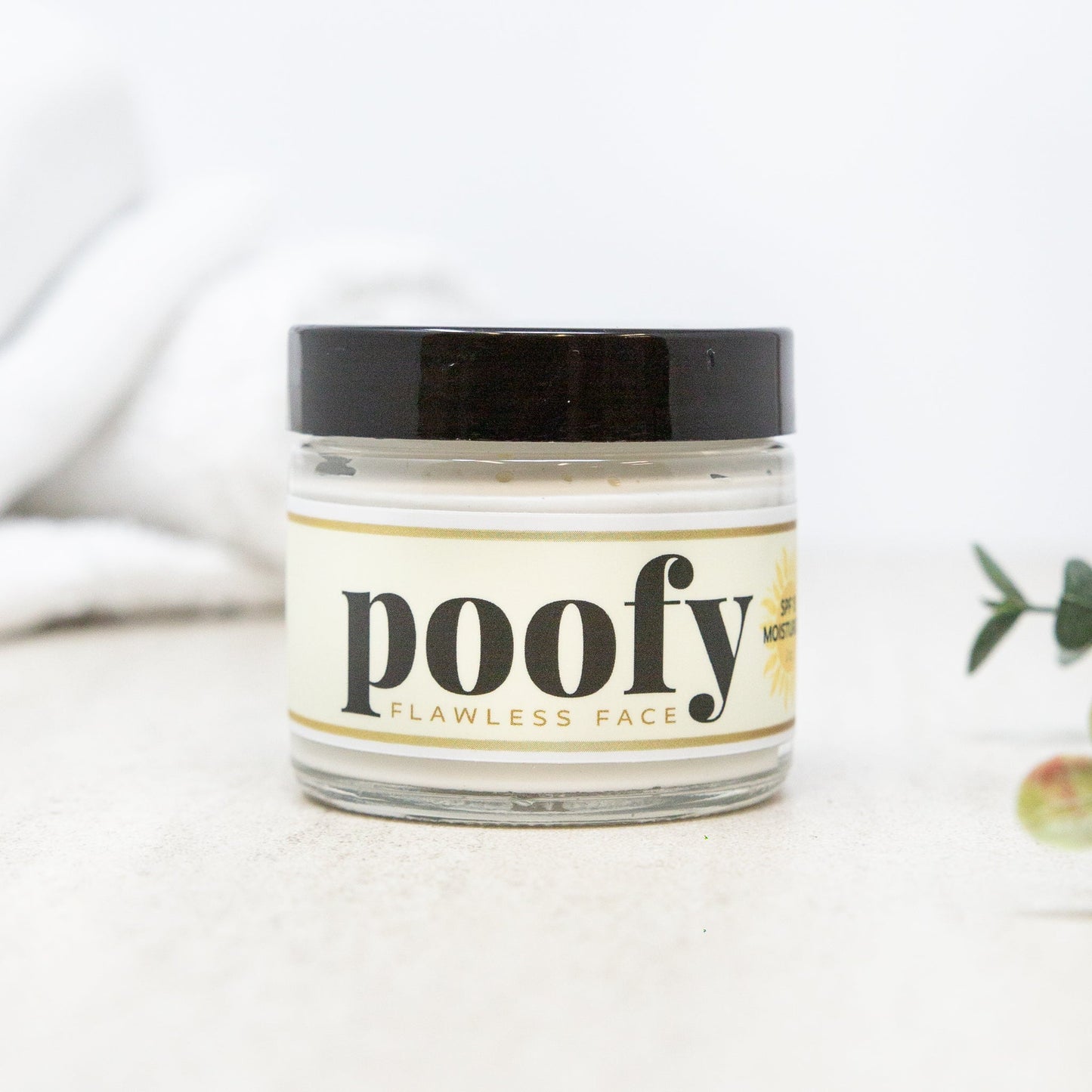 Face SPF moisturizer jar with black screw cap, cream-colored product, clear label