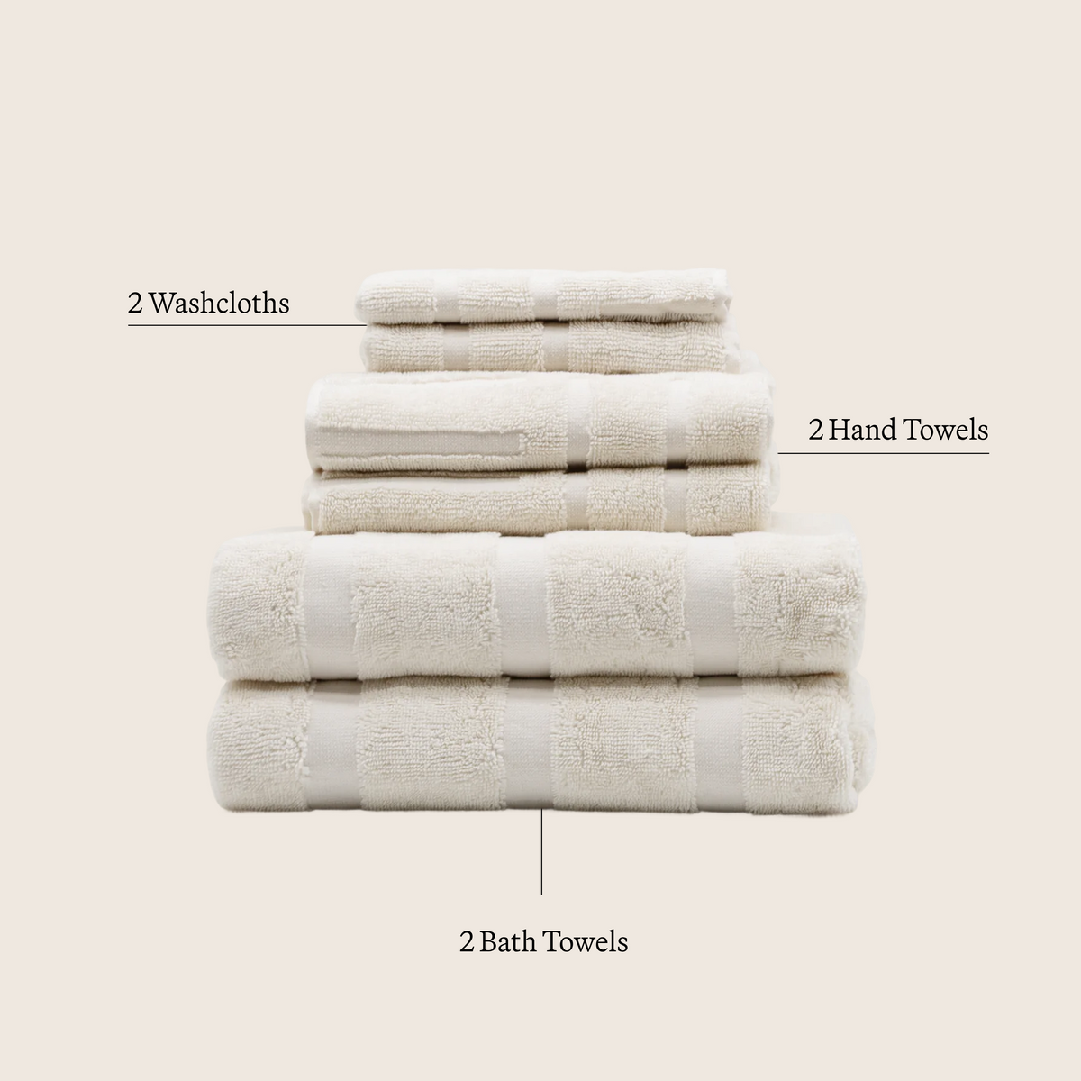 Set of ecru cotton towels: washcloths, hand towels, and bath towels stacked