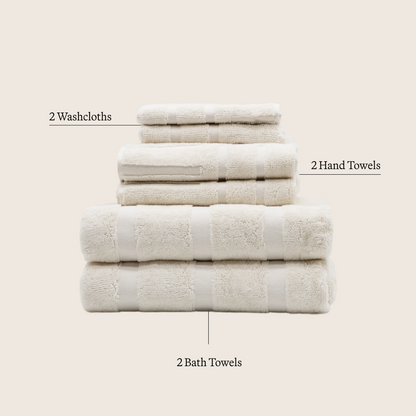 Set of ecru cotton towels: washcloths, hand towels, and bath towels stacked