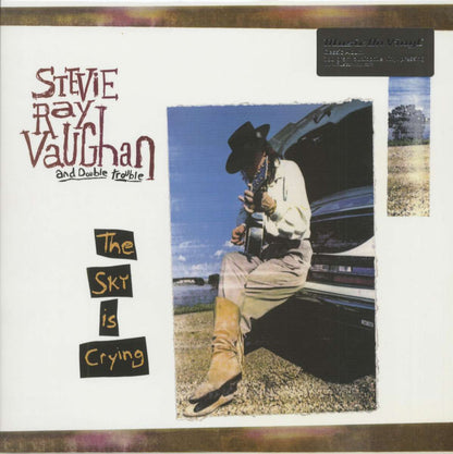Vinyl record album cover featuring guitarist in white shirt holding guitar