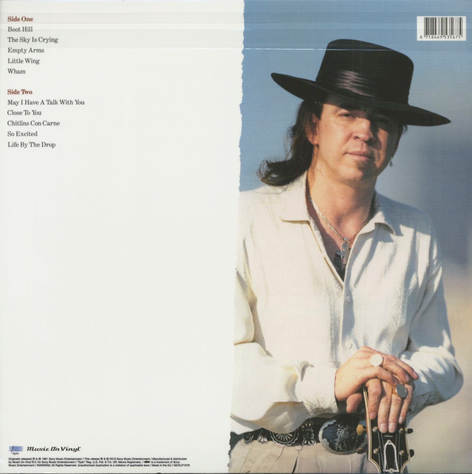 Vinyl record back cover with track list and portrait of man in hat