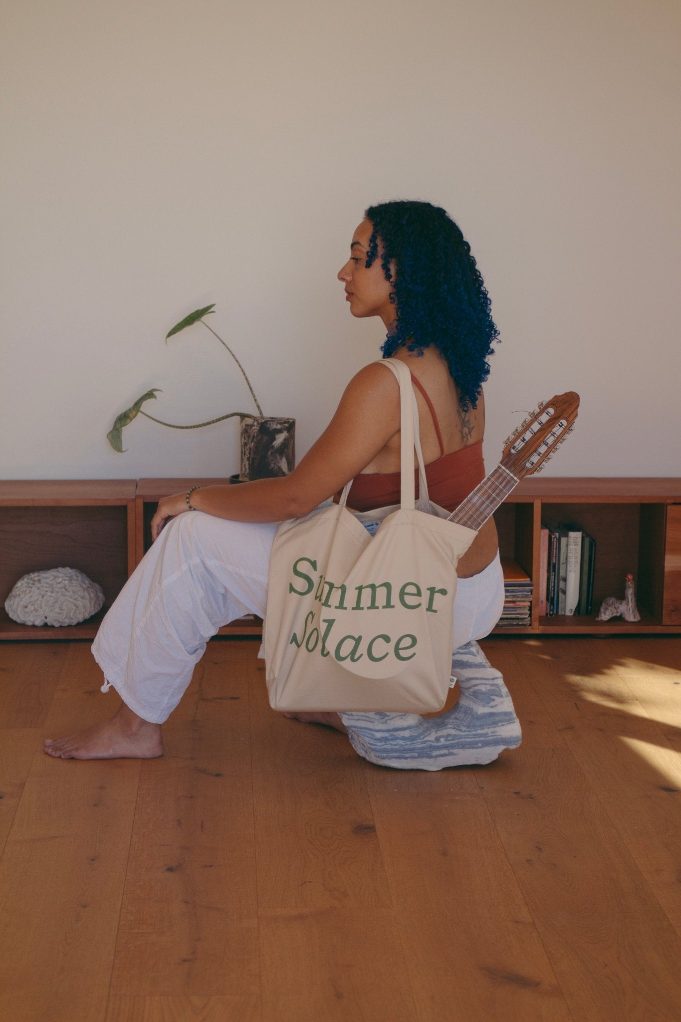 Off-white canvas tote bag with long handles and 'Summer Solace' front text