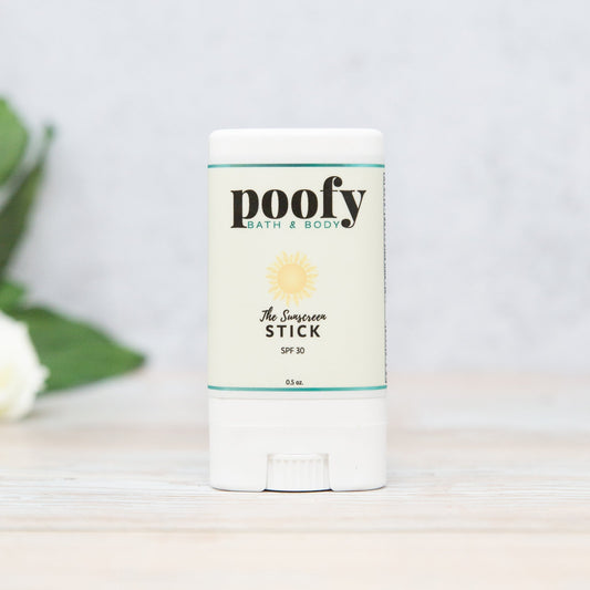 White sunscreen stick container with SPF 30 label and poofy logo