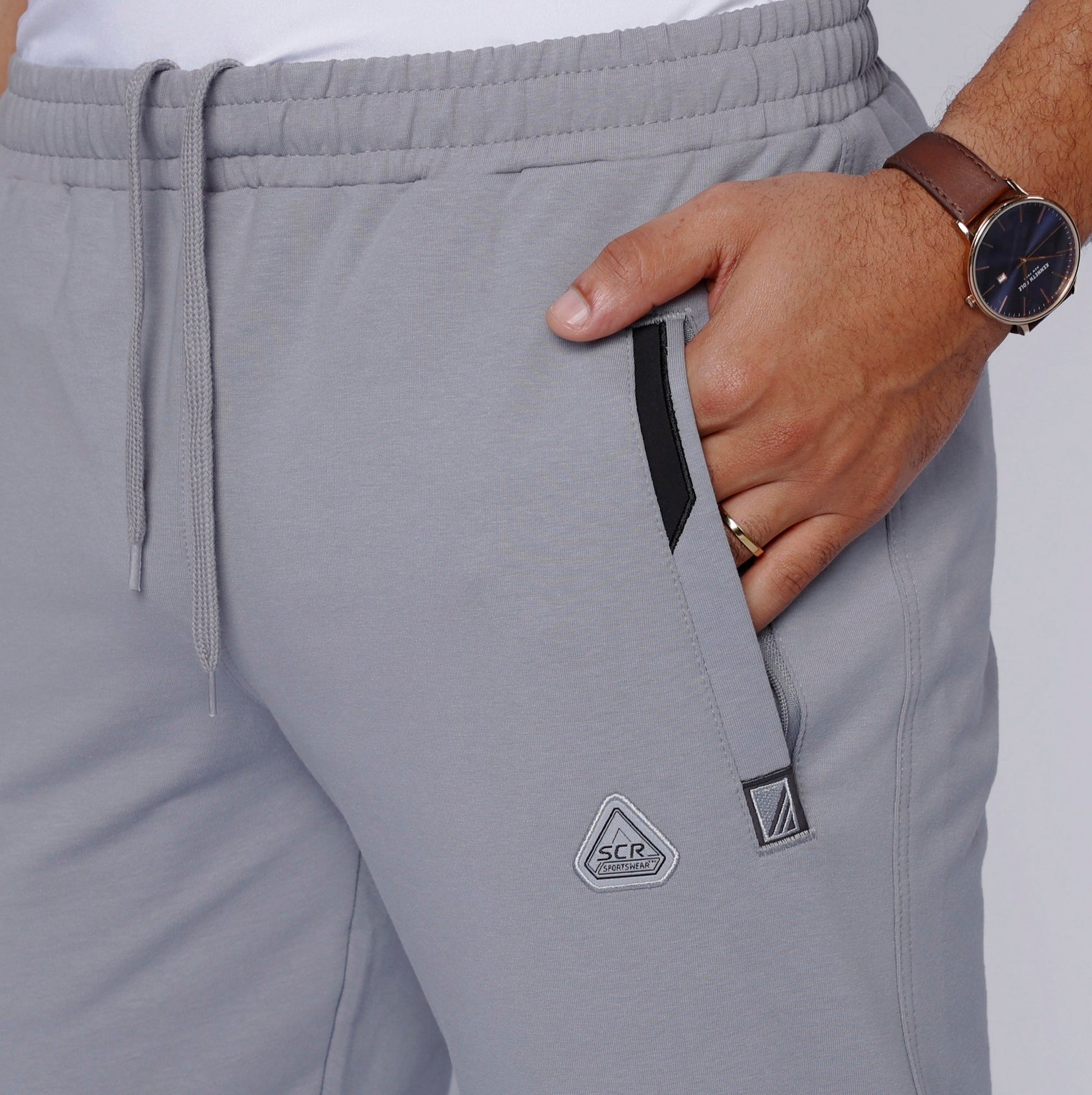 Men’s light gray heather sweatpants, elastic waistband and drawstring, side seam logo