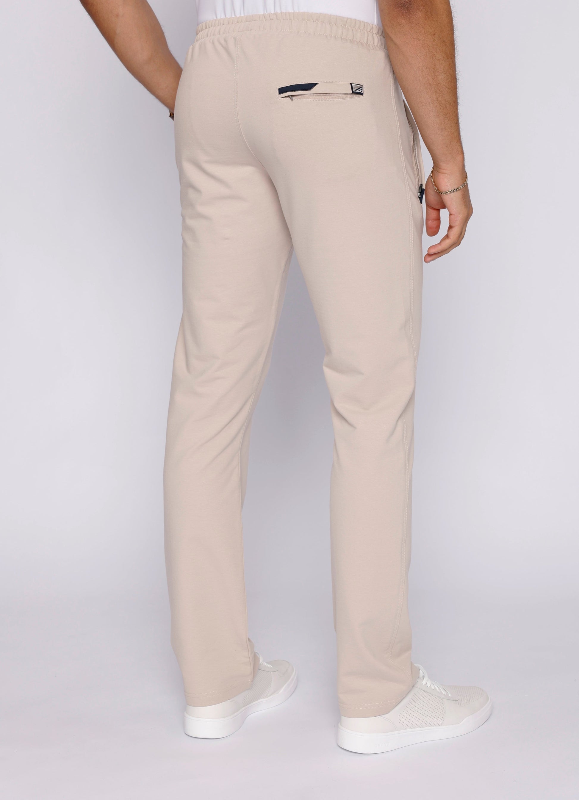 Light beige straight-fit athletic sweatpants with elastic waistband and side logo