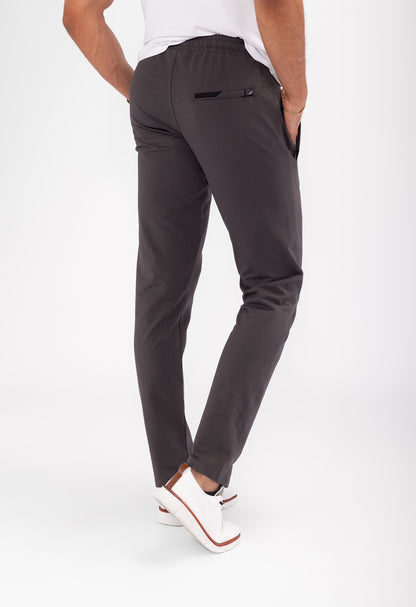 Athletic sweatpants with tapered legs and elastic waistband; dark grey with drawstring.