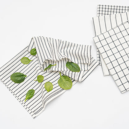 Kitchen towel set: striped and check towels in white with black lines, folded