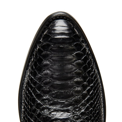 Black cowboy boot vamp close-up with crocodile-textured leather